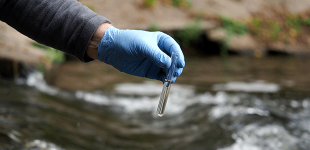 Picture of someone testing the water quality.